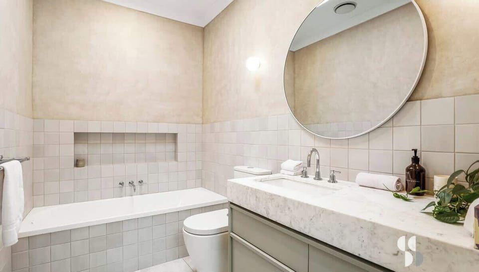 Main bathroom with bathtub and rain shower