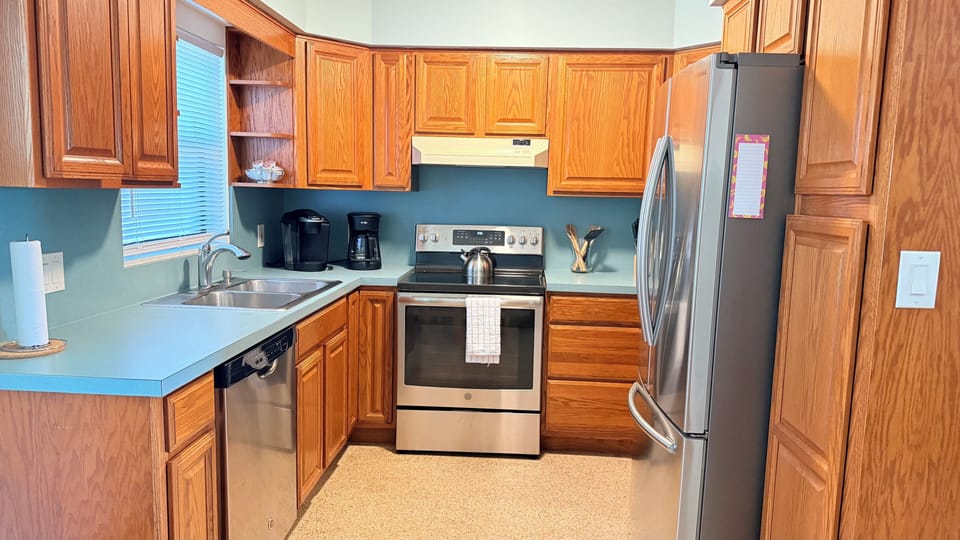 Fully equipped kitchen with cookware, coffee maker, and appliances.