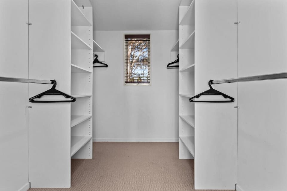There is plenty of storage in the walk-in wardrobe for all your personal belongings.