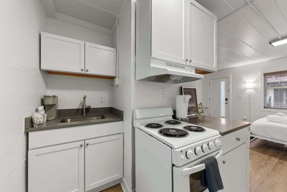 The sleek kitchen offers ample storage & every home comfort