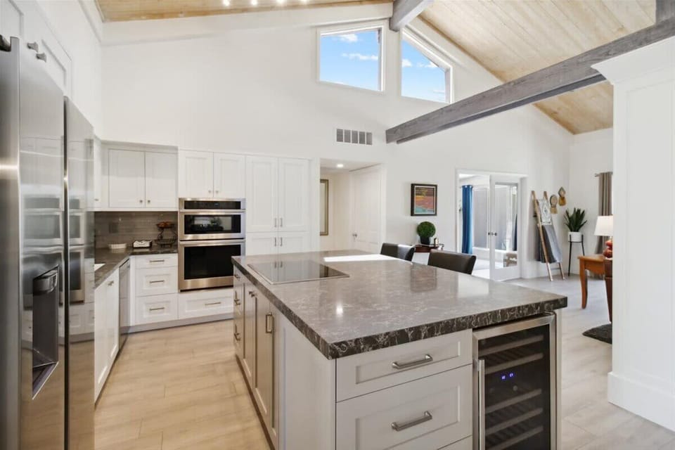 Chef-worthy kitchen with oven, wine fridge, and natural light.