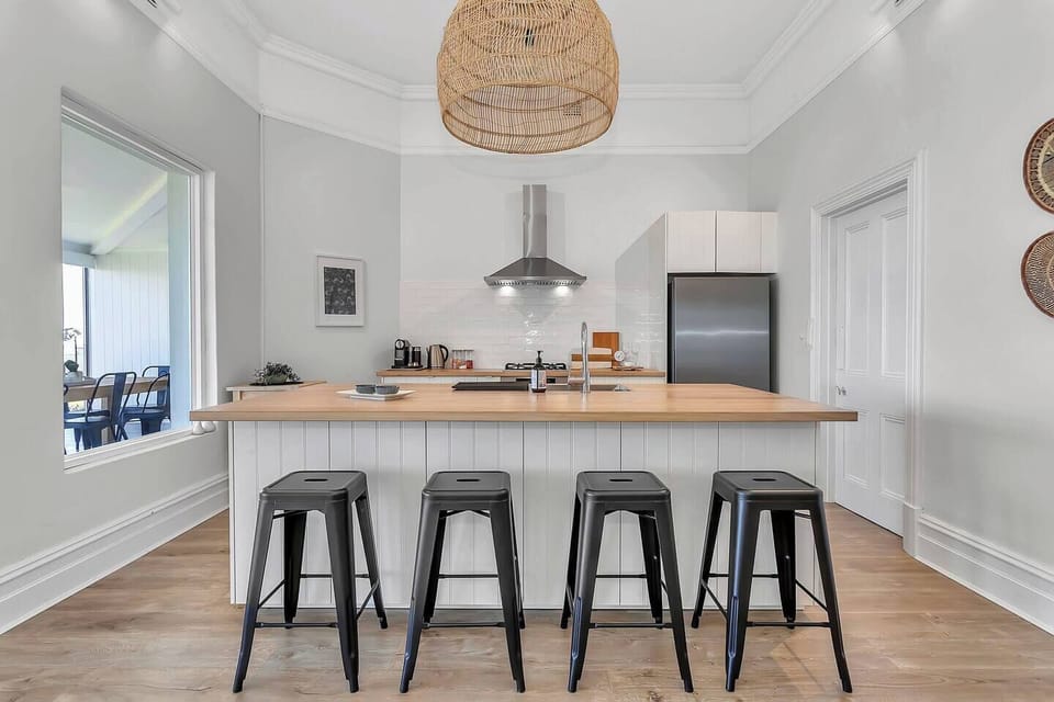 Gather around the spacious island bench for casual breakfasts, evening chats, or a glass of wine while dinner simmers on the stove.