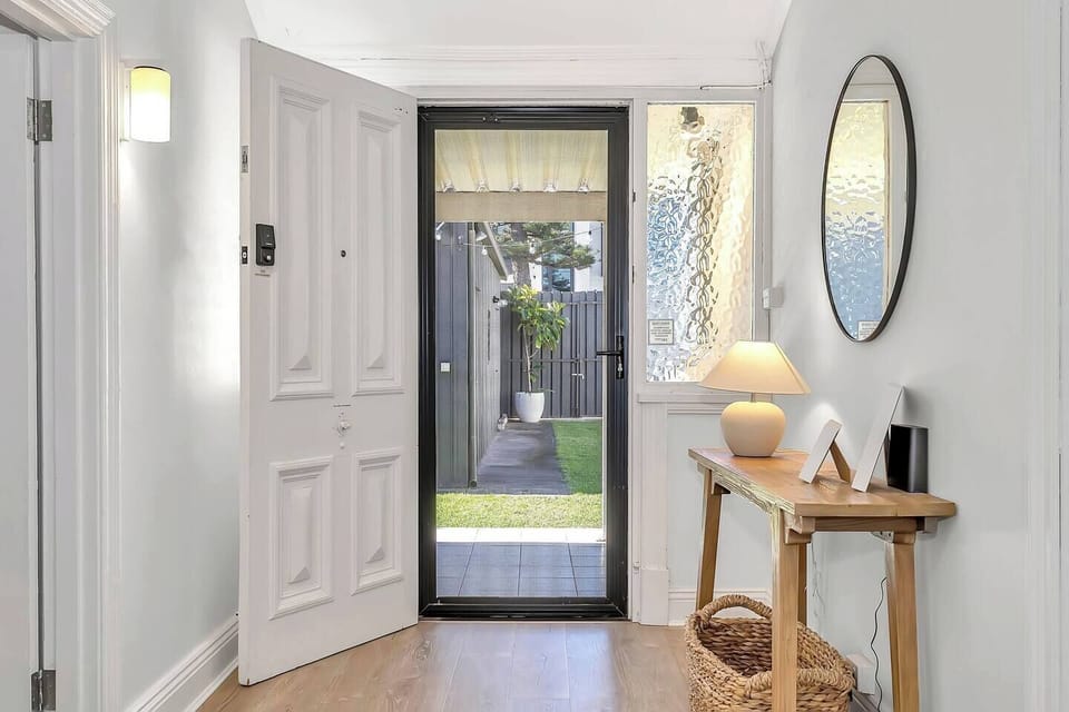 Step through the charming rear entrance and into a warm, welcoming hallway that leads you straight into your coastal retreat.