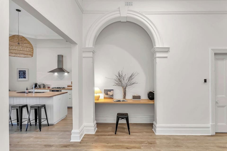 Whether working remotely or catching up on a good book, the dedicated study nook under heritage archways offers a quiet workspace.