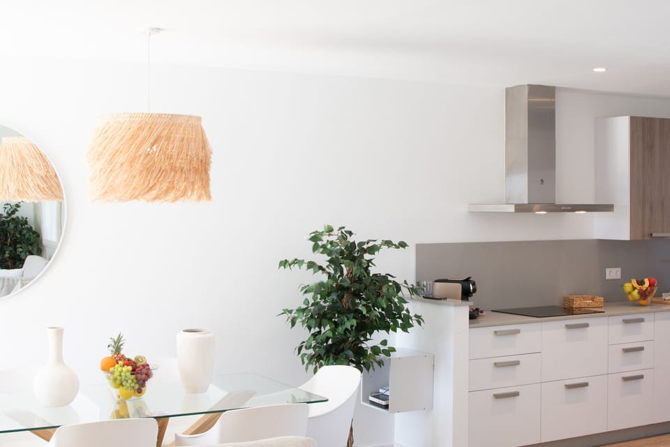 Indoor dining area open to the kitchen and very bright.