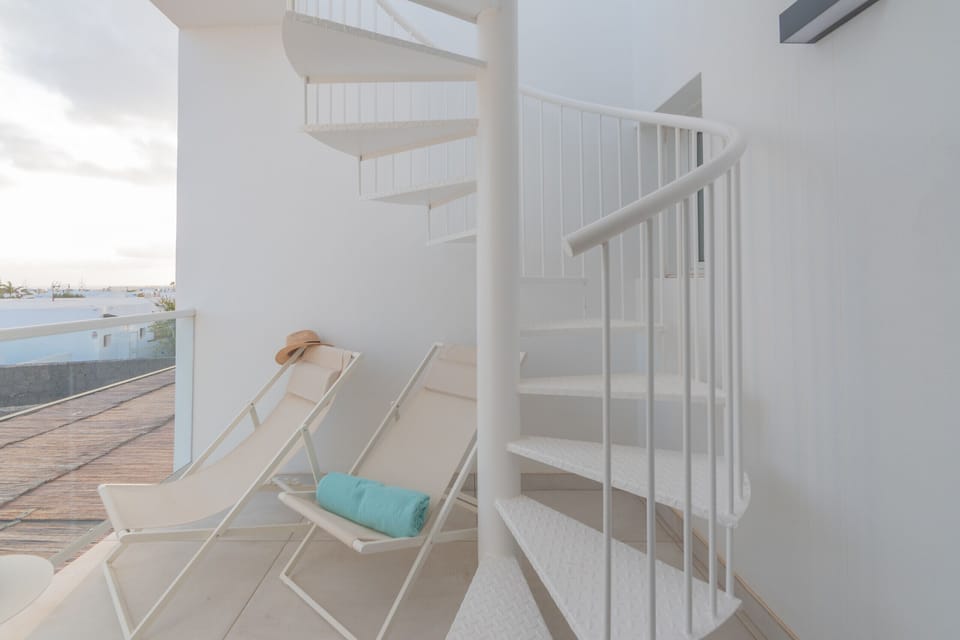 Exterior spiral staircase leading up to the solarium terrace.