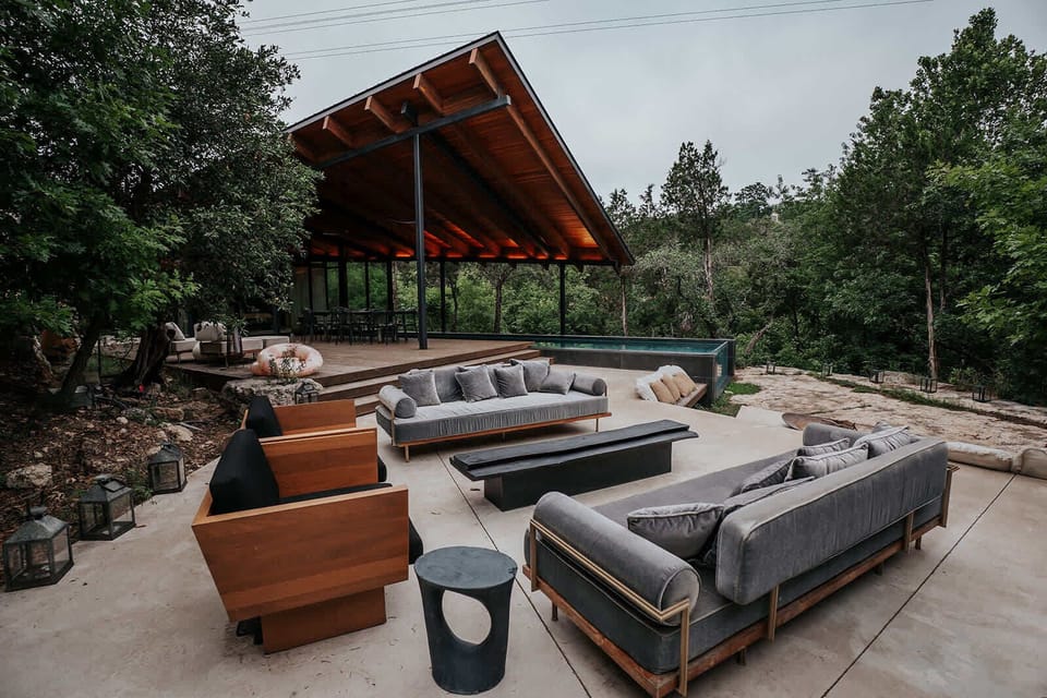 An architectural masterpiece in the trees. The seamless indoor-outdoor design features bespoke furnishings, a shaded pavilion, and tranquil forest views—crafted for refined gatherings and effortless relaxation