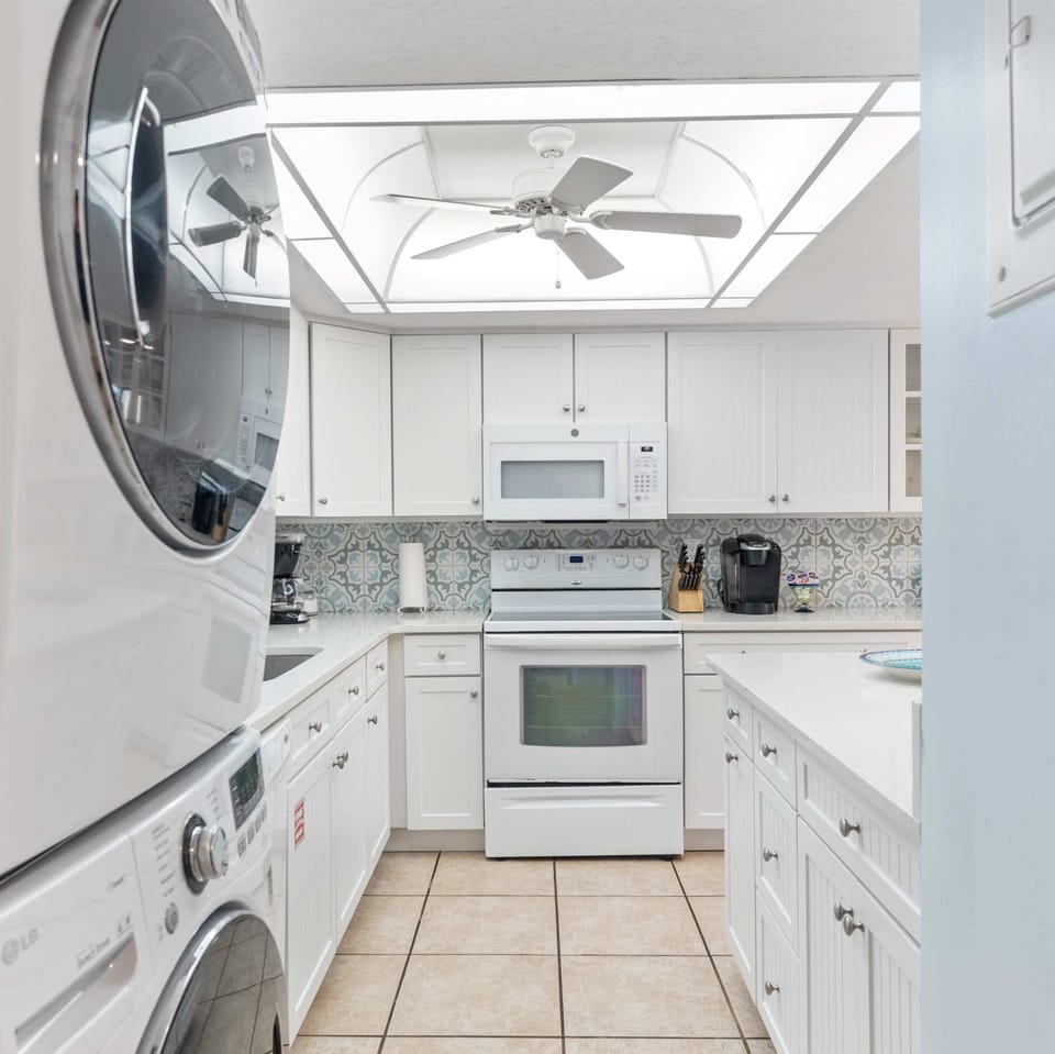 Private laundry is available for your stay, tucked away in the kitchen