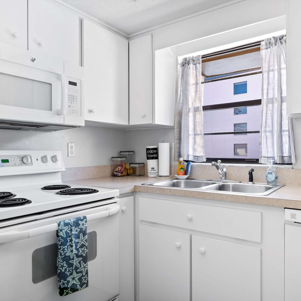 The sunny kitchen offers ample space & all the comforts of home