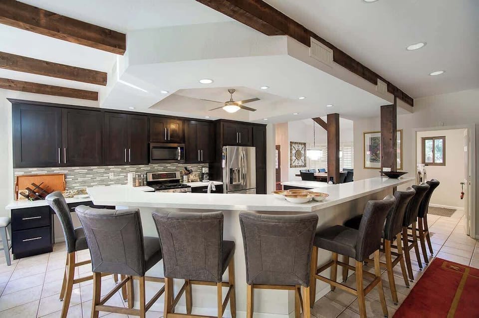 Spacious modern designed kitchen with pull out seats while waiting for the meal be ready and served.