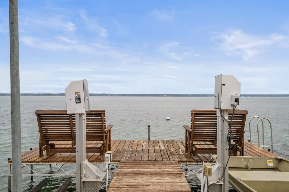 Relax by the water on this serene dock with stunning lake views, perfect for unwinding or enjoying a peaceful sunset. 🌅🚤