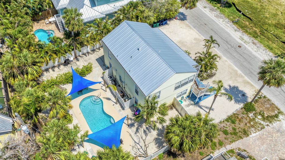 Your entire island escape awaits—two homes, one perfect retreat, just steps from the sugar-white sands of Anna Maria Island.