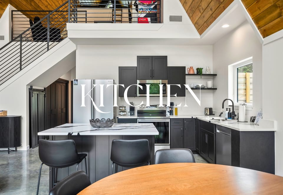 The kitchen keeps it sleek and functional with a center island, high-top seating, and everything you need to cook or snack in style.