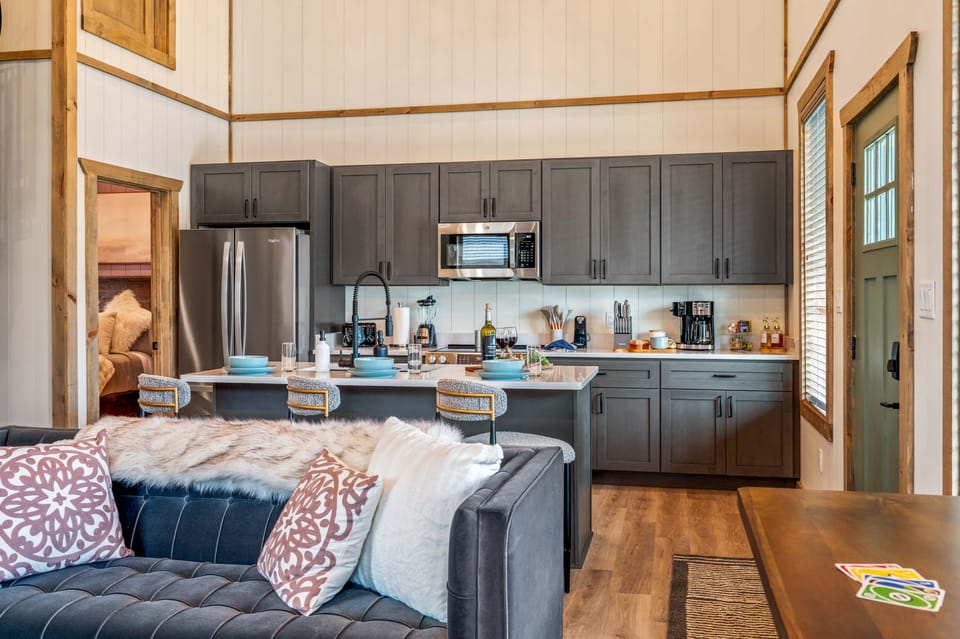 Inviting kitchen with gray cabinets and stainless-steel appliances.