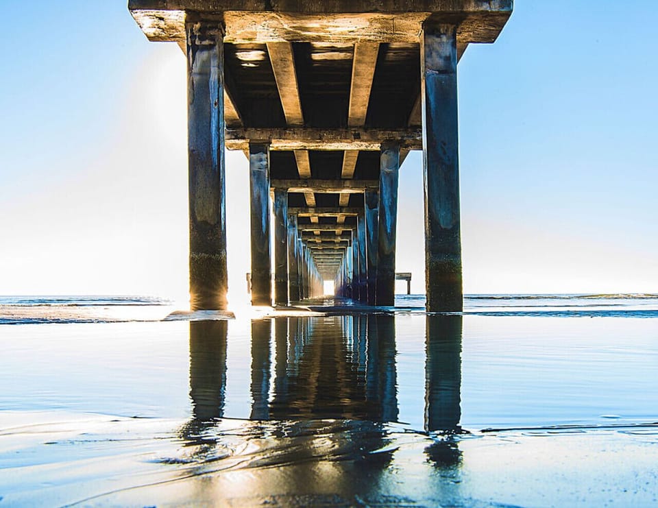 An iconic pier reaching into the sea, surrounded by sweeping beach views—ideal for fishing, sunset walks, and classic seaside moments.