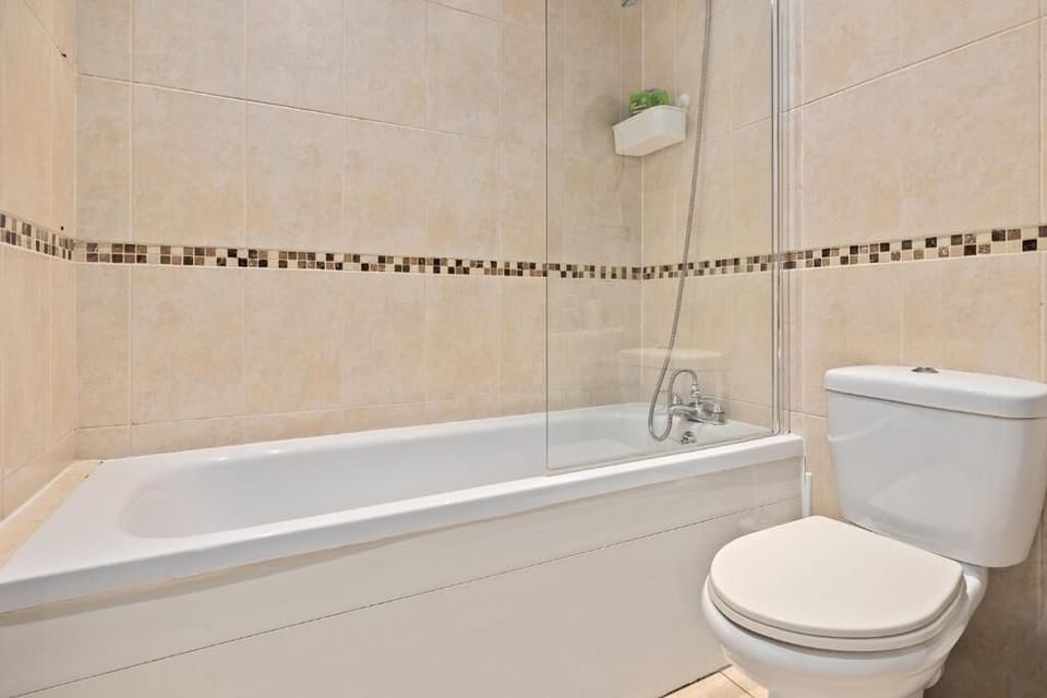 Relaxing bathroom with bathtub and freshly laundered towels.