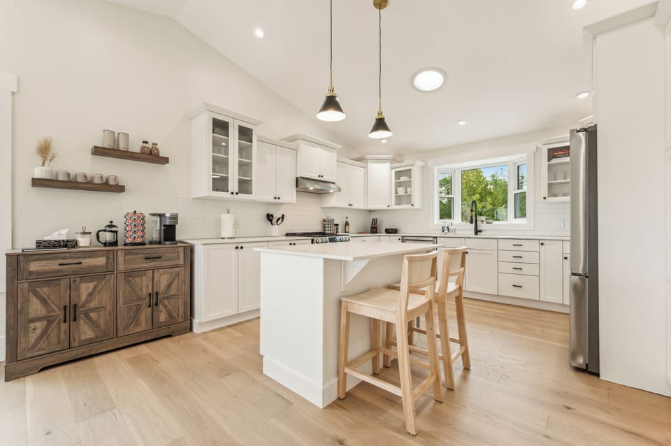 Bright, modern kitchen with a large island, top appliances, and plenty of space to cook and connect during your stay.