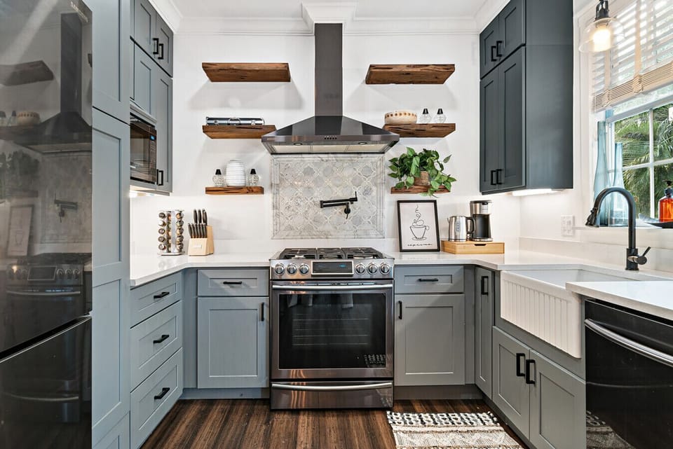  A stylish kitchen with sleek gray cabinets and warm wood accents. Imagine preparing delicious meals in this well-equipped space.