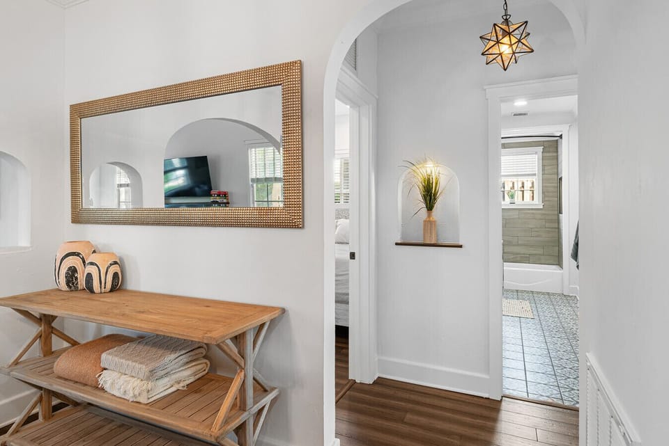 An inviting entryway with a stylish mirror and console table offers a warm welcome into the home.