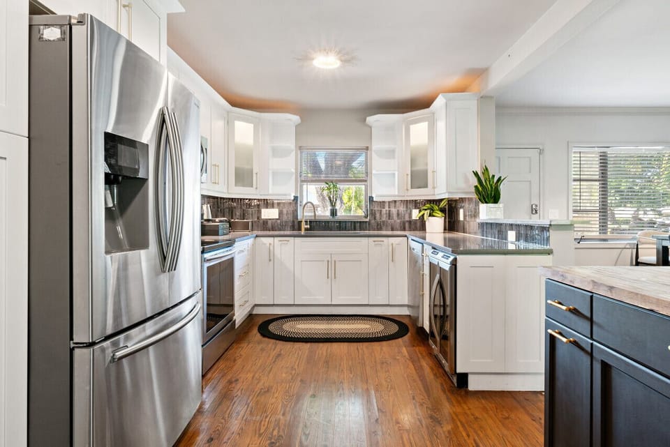 Prepare meals with ease in this spacious, modern kitchen featuring stainless steel appliances and ample counter space.

