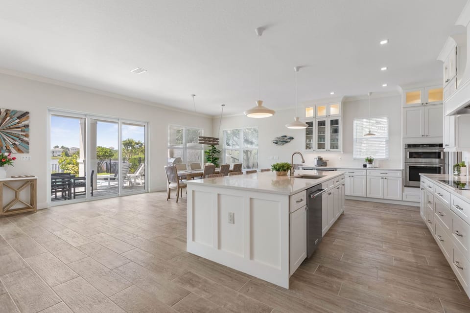 Open Concept Kitchen, Dining and Living Room on the ground floor with Glass Doors leading out to the Patio.
