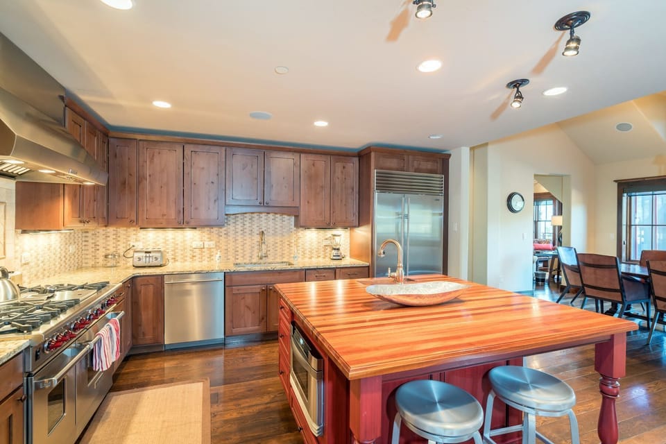 Kitchen - Chef's kitchen equipped with a wine fridge and top-of-the-line stainless steel appliances