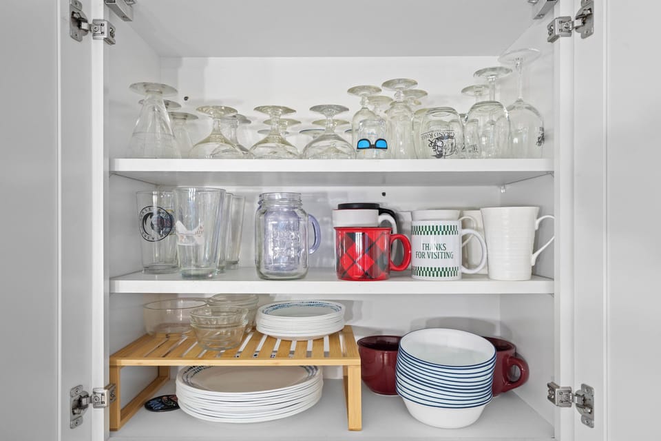 Cabinet full of dishes and glasses for your use. 