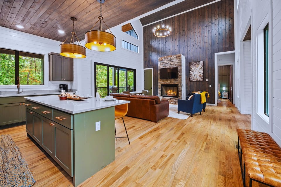 Living Room: Bright and airy space with a stunning fireplace and woodland views for relaxation!