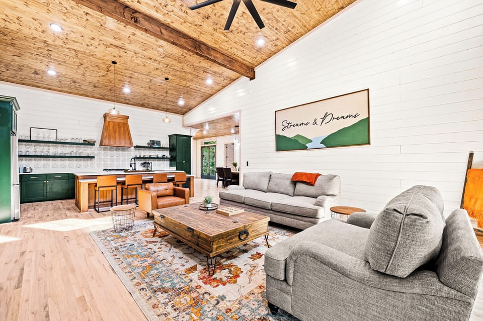 Open-concept living room with tall ceilings, cozy gas fireplace & Smart TV — perfect for family movie nights.