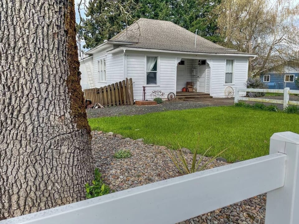 Schoolhouse has a yard, swing, and picnic table.