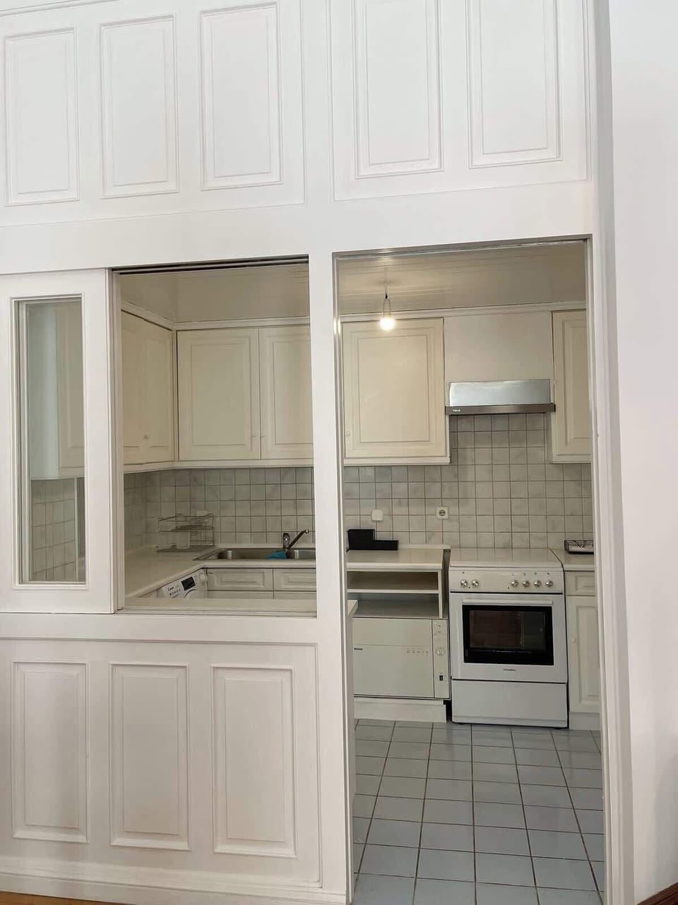 Kitchen with a window into the living room