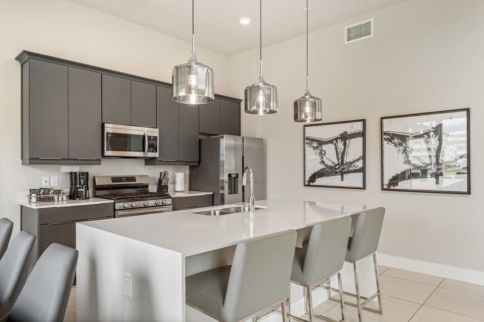 Experience extended stays in this modern kitchen-equipped home! Features include stainless steel appliances, a spacious island, and stylish lighting. Perfect for cooking, dining, and relaxing. Enjoy a comfortable, long-term stay in style. Book now!
