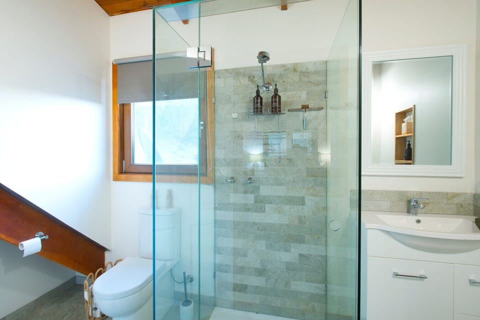 Modern ensuite, featuring shower, sleek vanity, & Eloura Australia Amenities