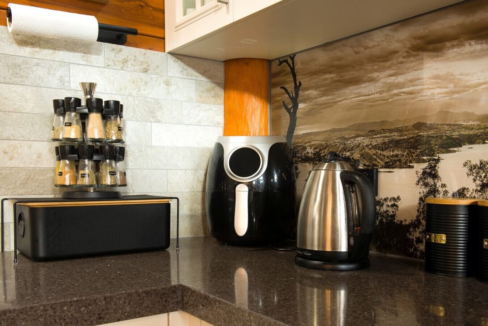 Kitchen features modern appliances and a scenic backdrop replicating the stunning lookout nearby