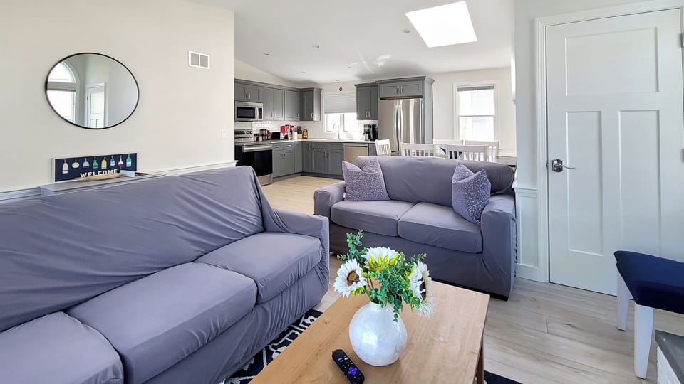 Living room with dining area and kitchen beyond