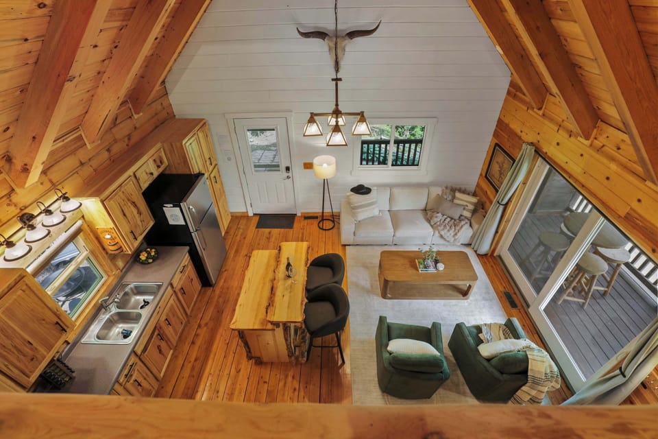 A-frame interior design of the big cabin with open concept living and walkout access to the deck.