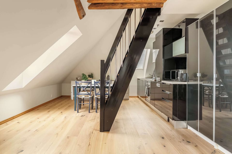 Dining area with natural light and exposed wood beams.