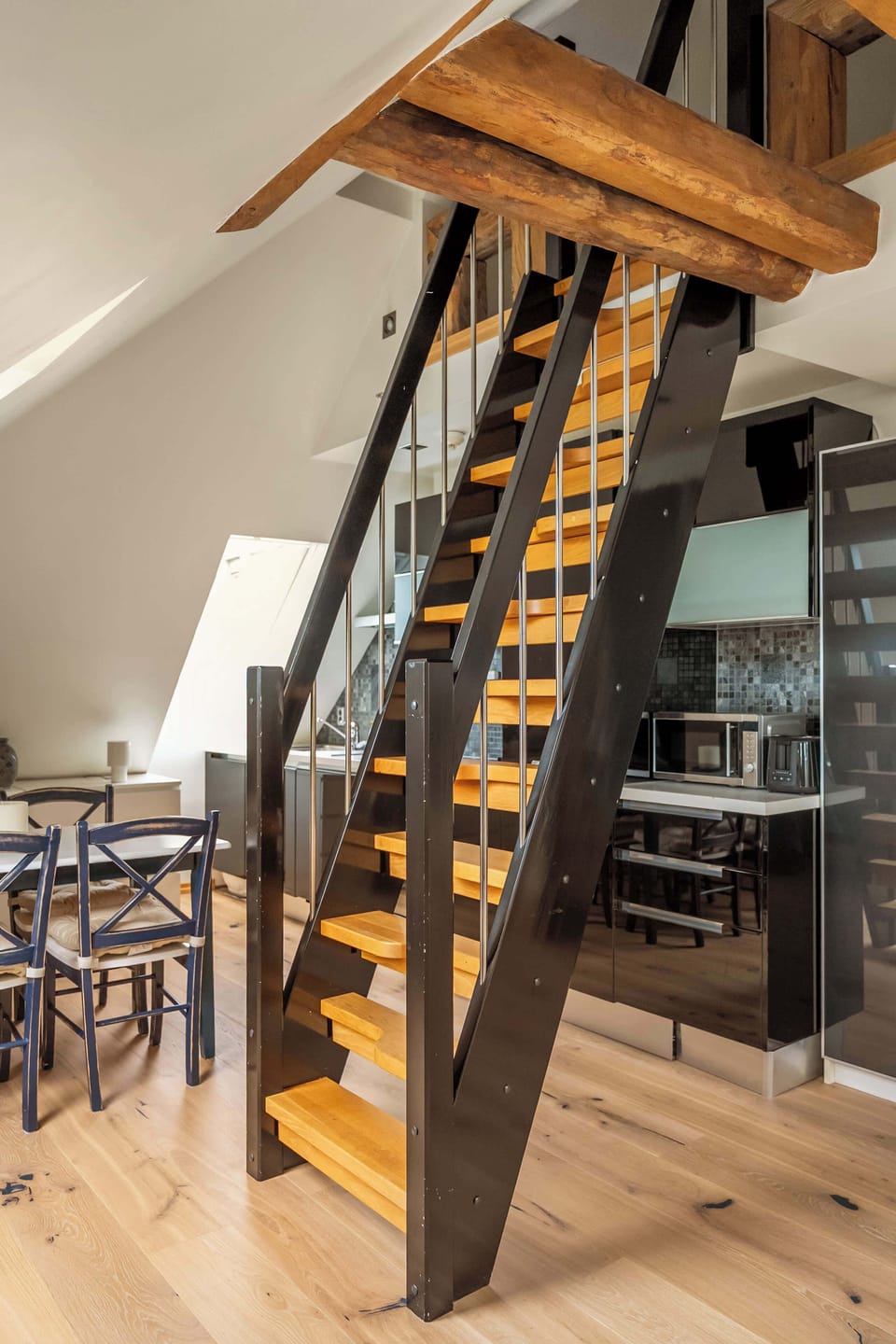 Light-toned hardwood floors complement the dark-stained staircase.