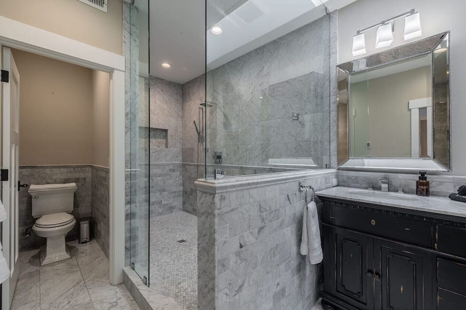 Relax in your ensuite bathroom, featuring a jacuzzi tub and dual showerheads for the ultimate comfort.