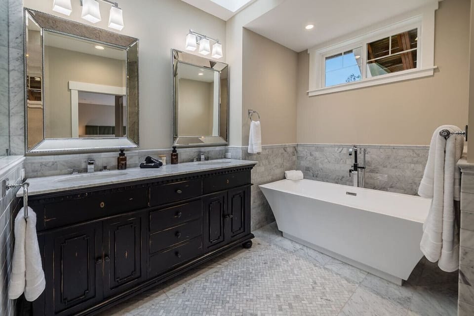 Enjoy a luxurious bath or shower in a bathroom that blends comfort with elegance.