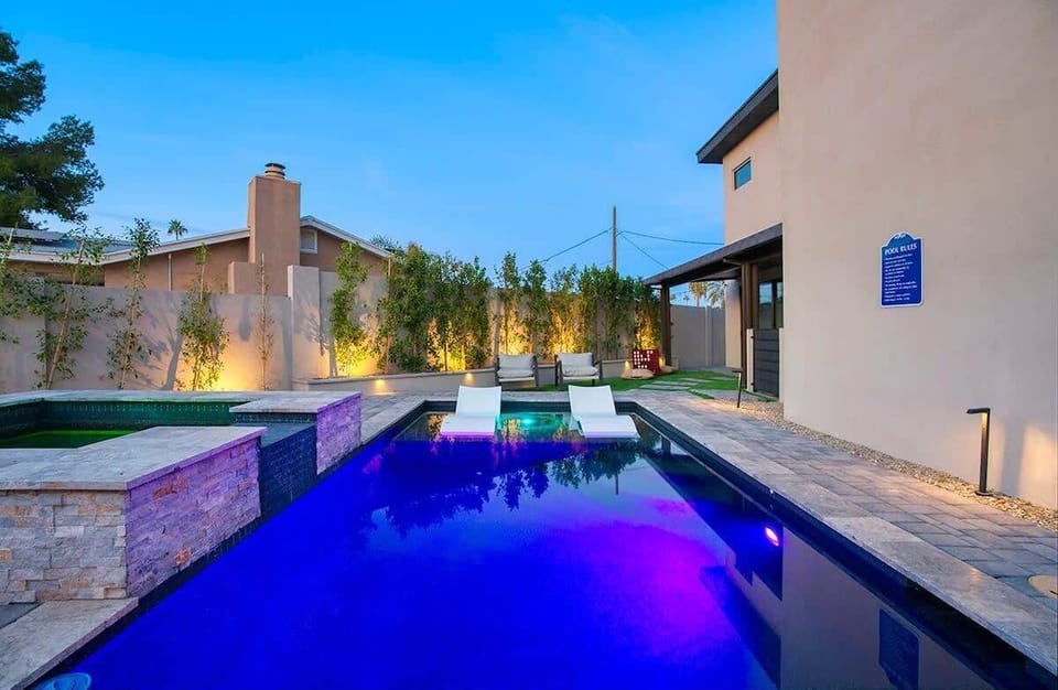 Dive into your own backyard oasis with stunning purple LED lighting and desert mountain views.
