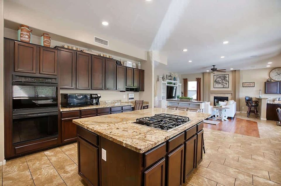 Chef-ready kitchen with gas range, granite island, and tons of counter space.