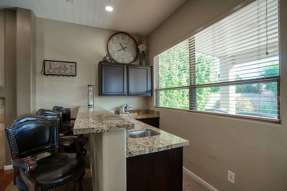 Granite breakfast bar with garden views and easy access to the patio.