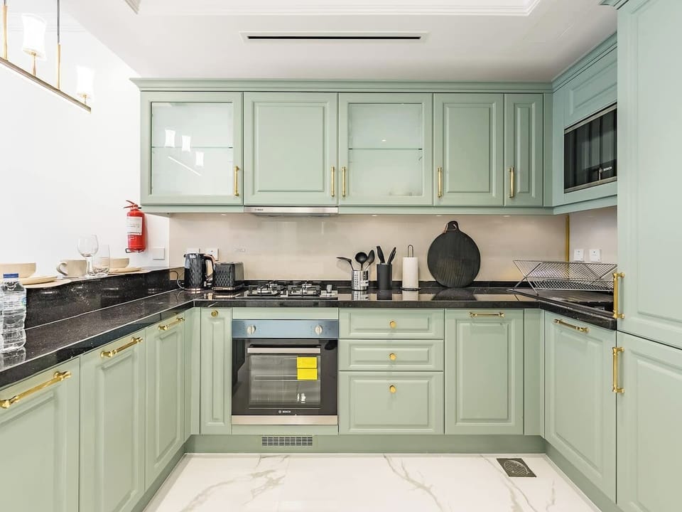 Open kitchen design with a full range of modern appliances and a built-in fridge, perfect for effortless cooking.