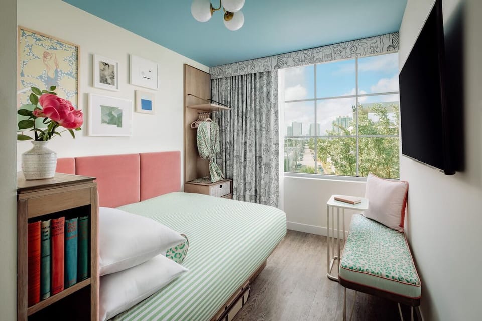 Wake up to sunshine and skyline views from plush bedding.