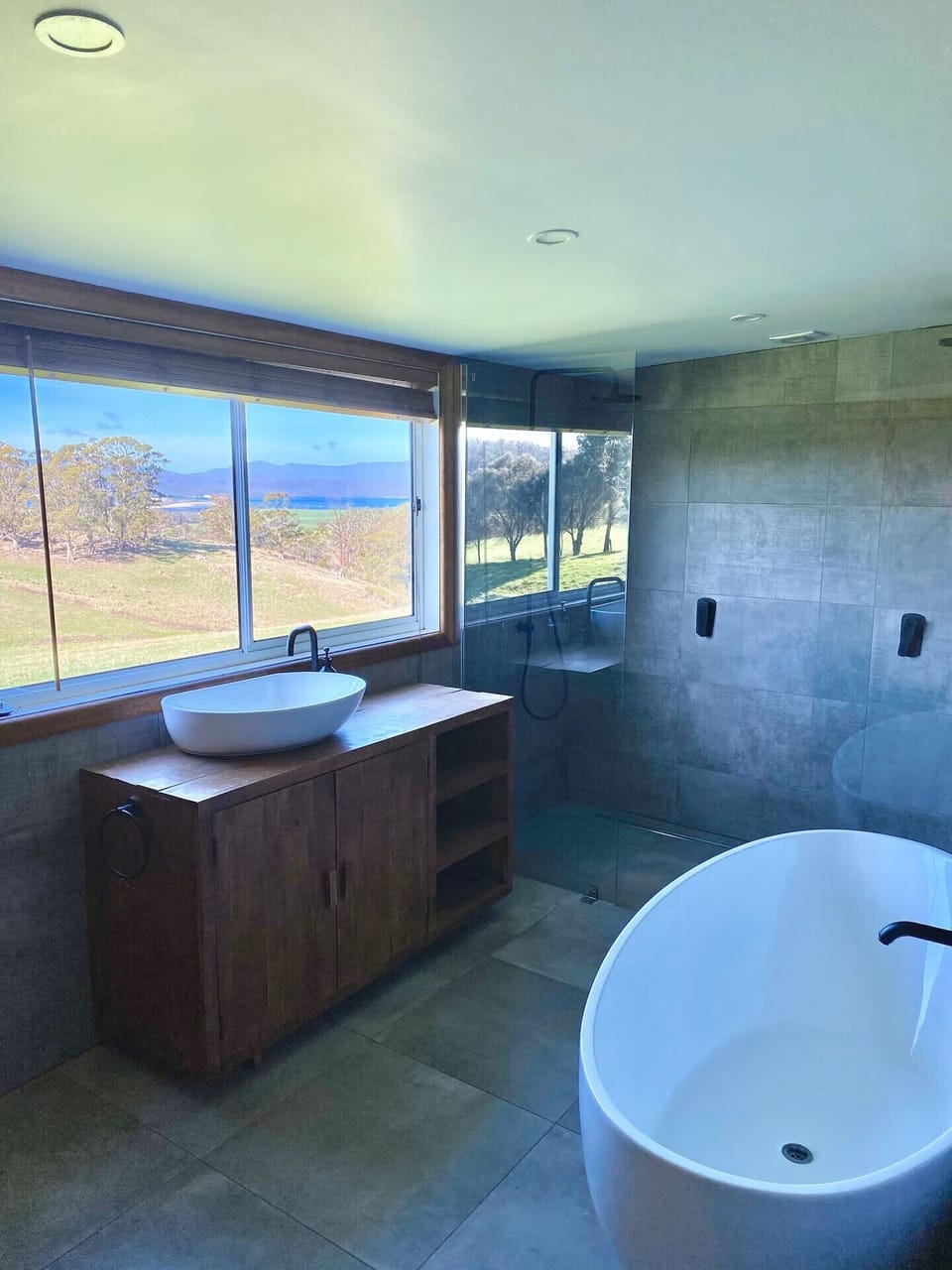 Bathroom with bathtub and double shower. 
