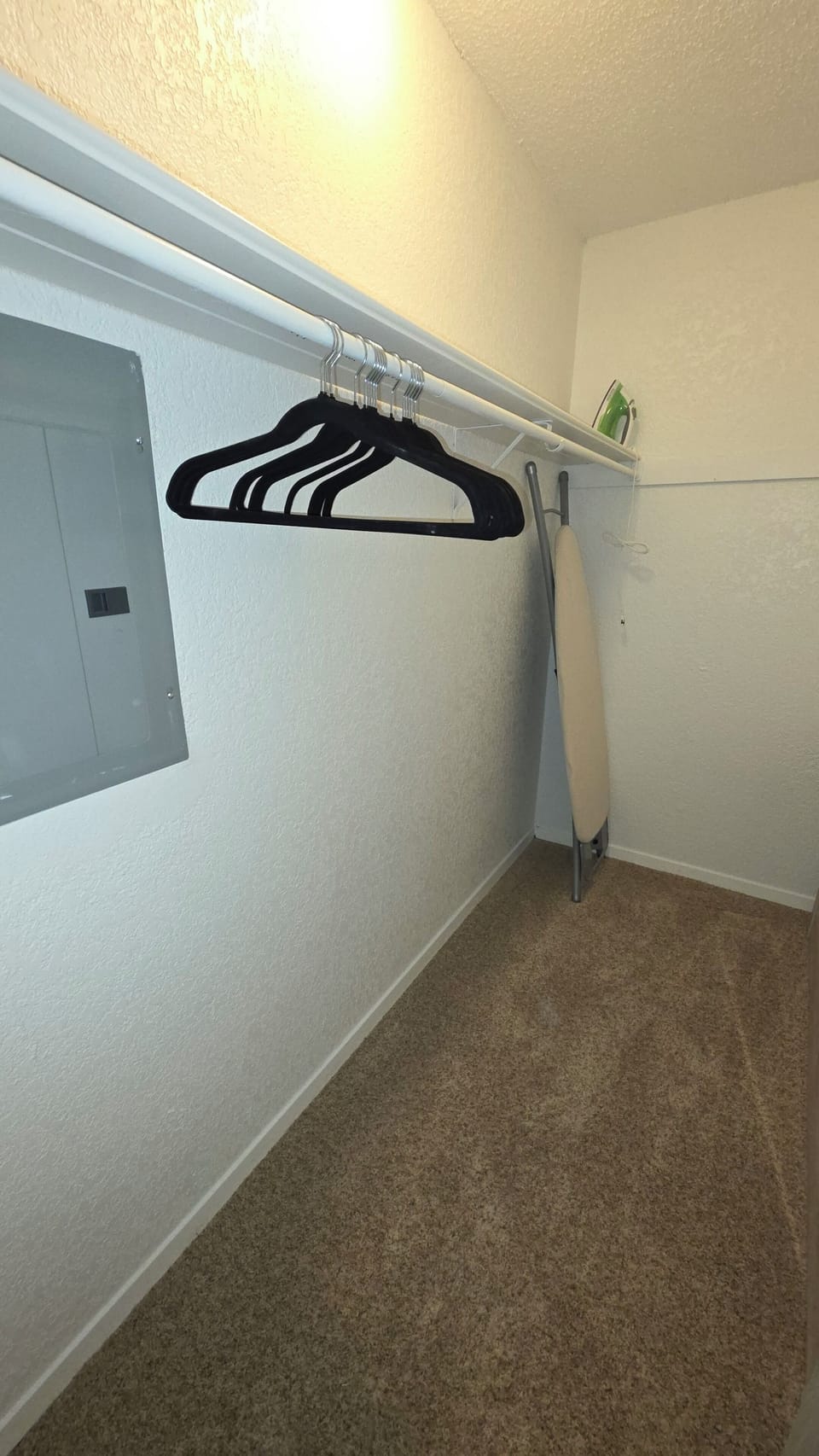 Large Walk In Closet with Ironing board, Iron, and Hangers