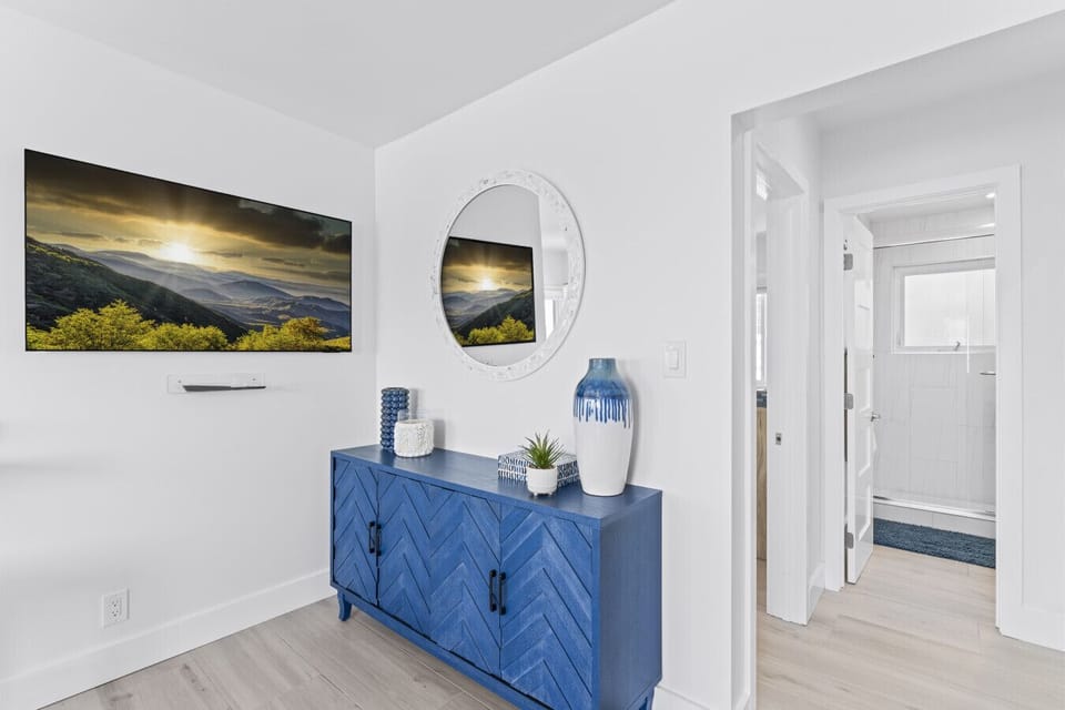 Elegant hallway with a coastal touch and serene artwork.