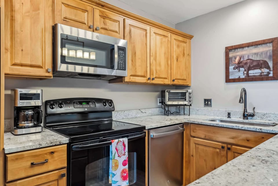 Kitchen: Drip coffee maker, Crockpot, blender, toaster, kettle, cooking utensils, tableware
