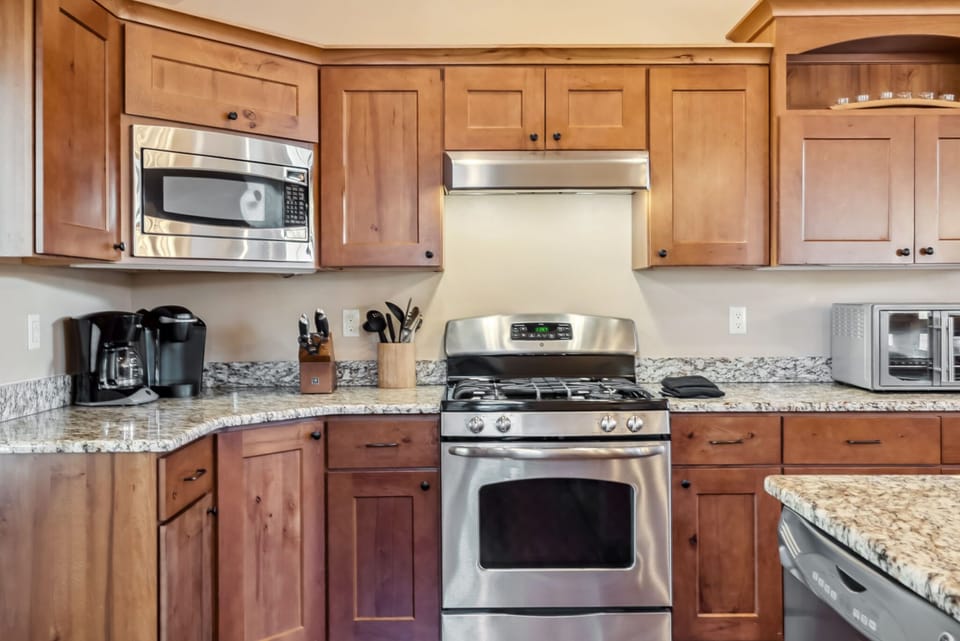 Kitchen: Main floor, drip coffee maker, Keurig, toaster, cooking utensils, tableware